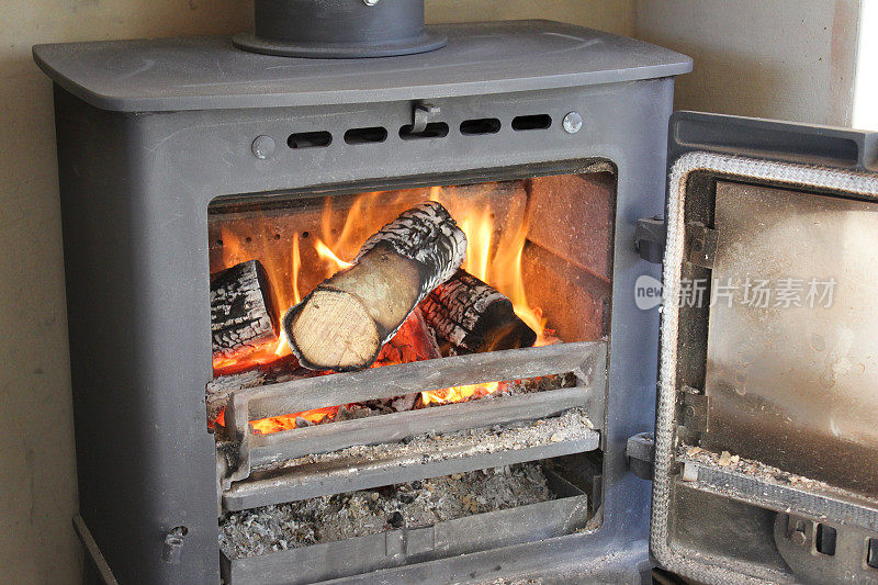 咆哮的火/火焰的图像，燃烧木材的多燃料炉/壁炉，门打开